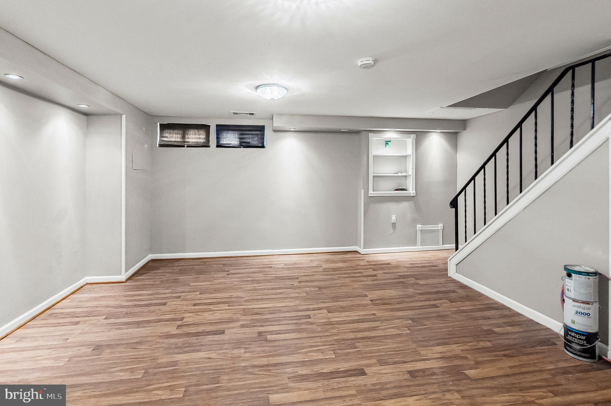 6955 Blanche Road Baltimore, MD 21215 - Photo 18 of 26 a view of an empty room with wooden floor and stairs