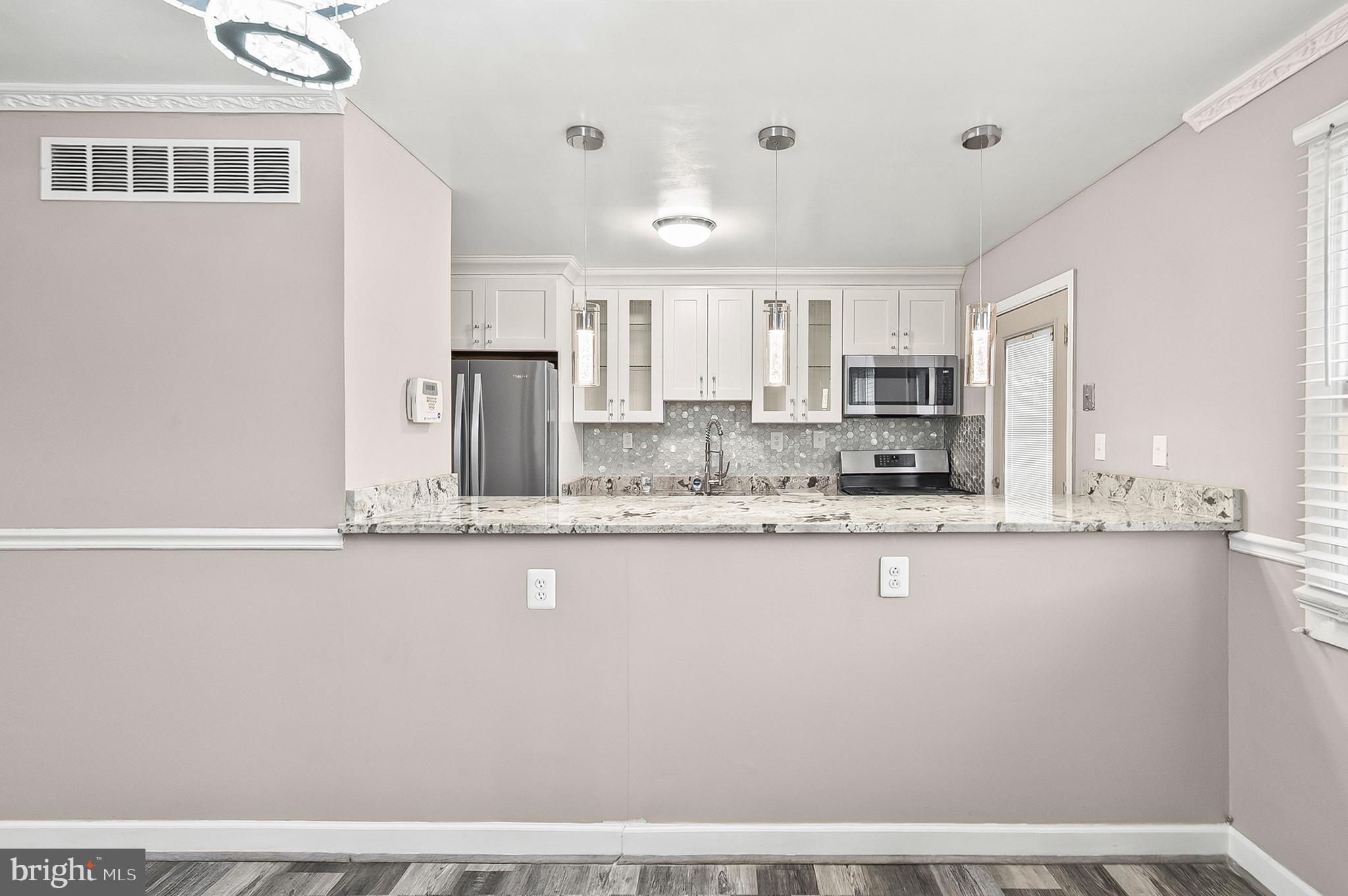 6955 Blanche Road Baltimore, MD 21215 - Photo 5 of 26 a kitchen with stainless steel appliances granite countertop a sink a stove and a refrigerator