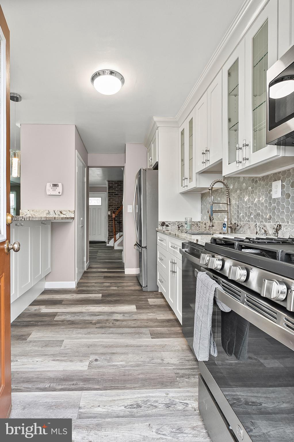 6955 Blanche Road Baltimore, MD 21215 - Photo 7 of 26 a kitchen with stainless steel appliances granite countertop a stove and a refrigerator