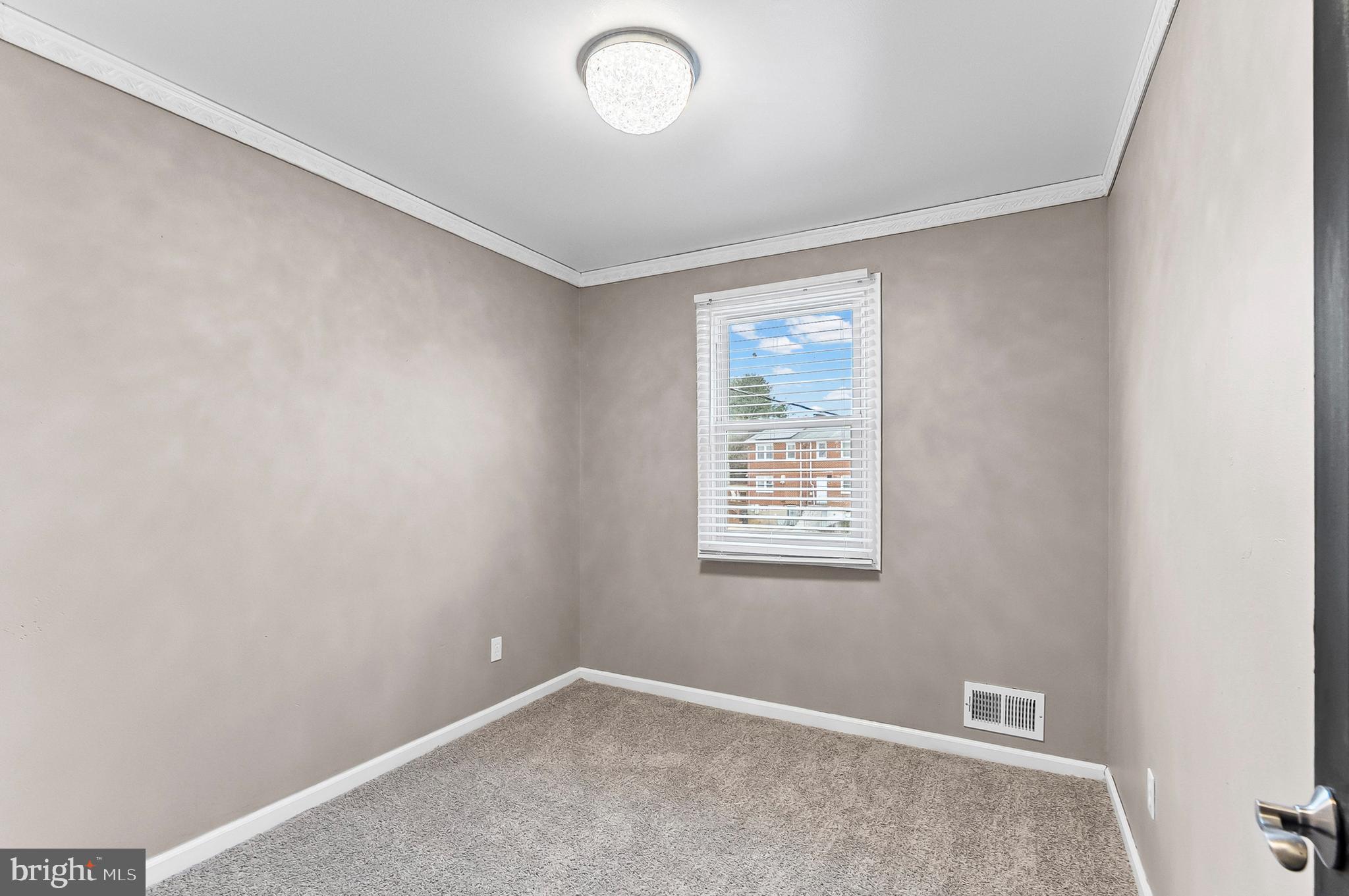 6955 Blanche Road Baltimore, MD 21215 - Photo 9 of 26 an empty room with windows