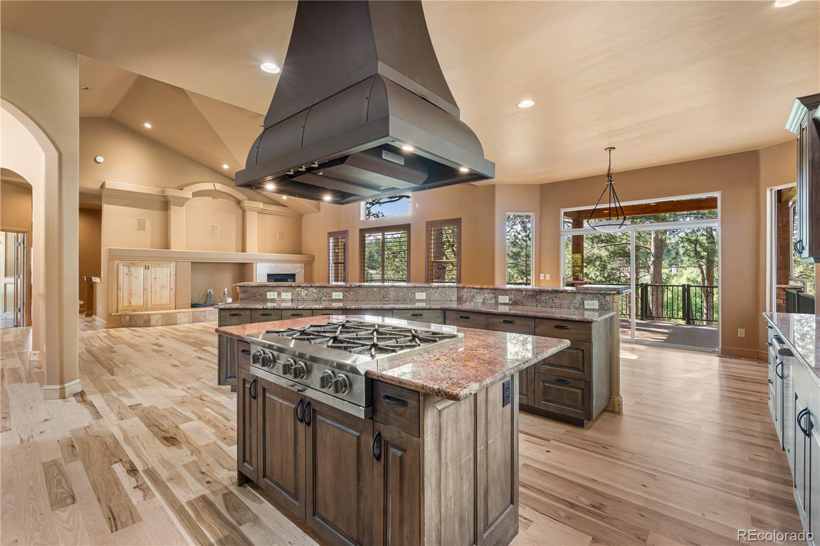 691 Cumberland Road Larkspur, CO 80118 - Photo 13 of 43 a kitchen with stainless steel appliances granite countertop a stove and a wooden floors