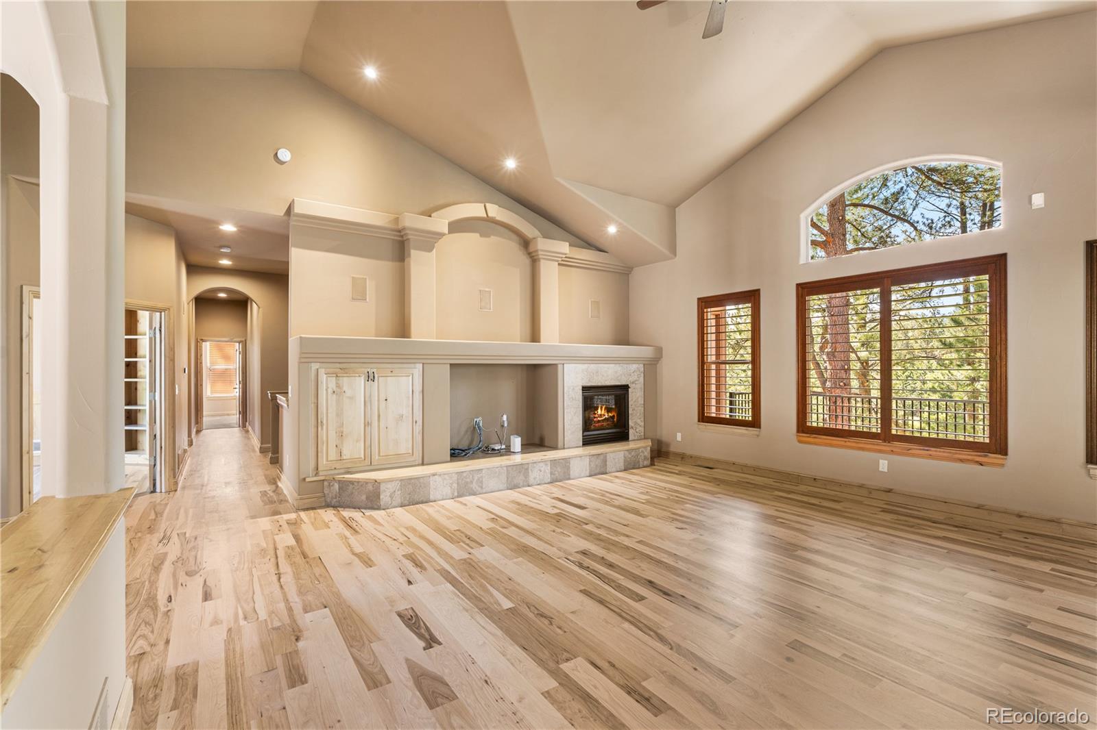 691 Cumberland Road Larkspur, CO 80118 - Photo 17 of 43 a view of an empty room with wooden floor and a window