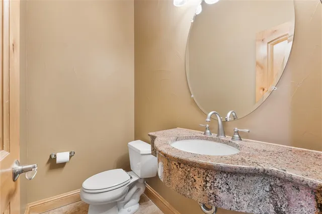 a bathroom with a granite countertop sink a vanity and shower