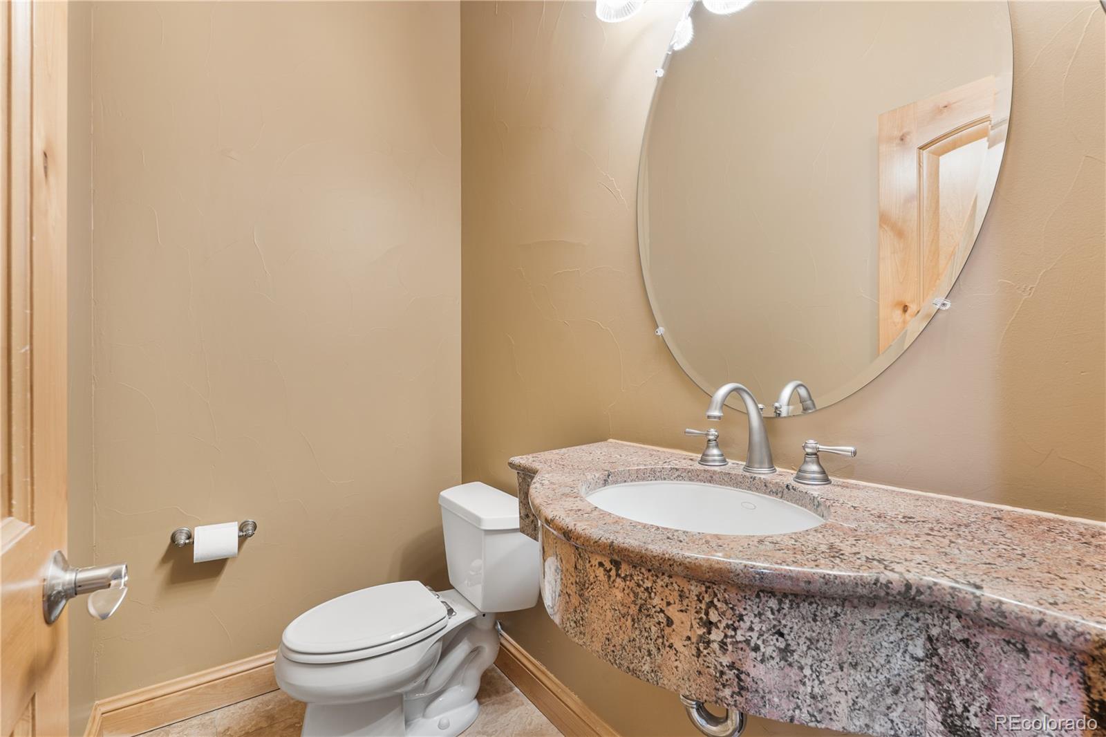 691 Cumberland Road Larkspur, CO 80118 - Photo 19 of 43 a bathroom with a sink a toilet and a mirror