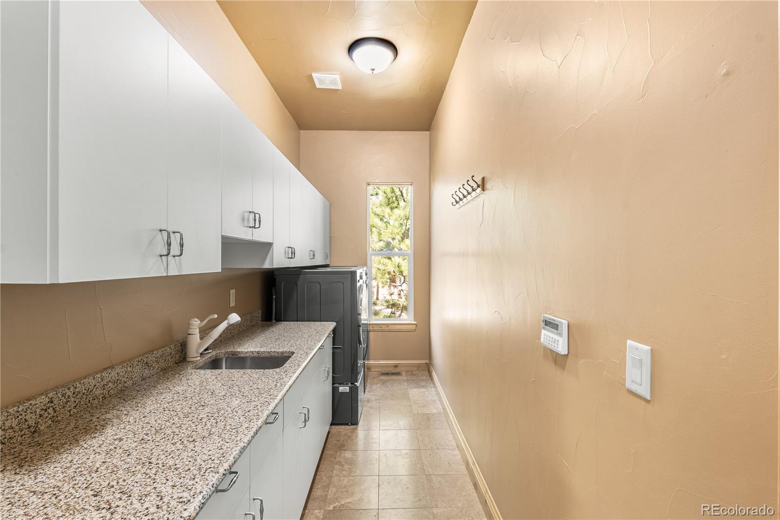 691 Cumberland Road Larkspur, CO 80118 - Photo 20 of 43 a bathroom with a granite countertop sink a vanity and shower