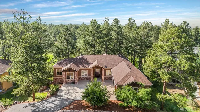 an aerial view of a house with yard and outdoor seating