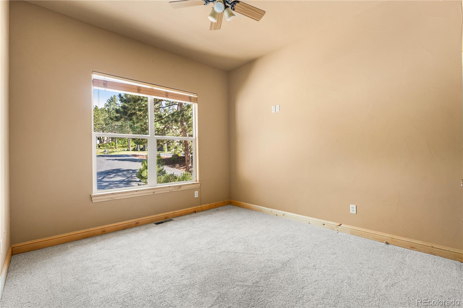 691 Cumberland Road Larkspur, CO 80118 - Photo 24 of 43 an empty room with a window