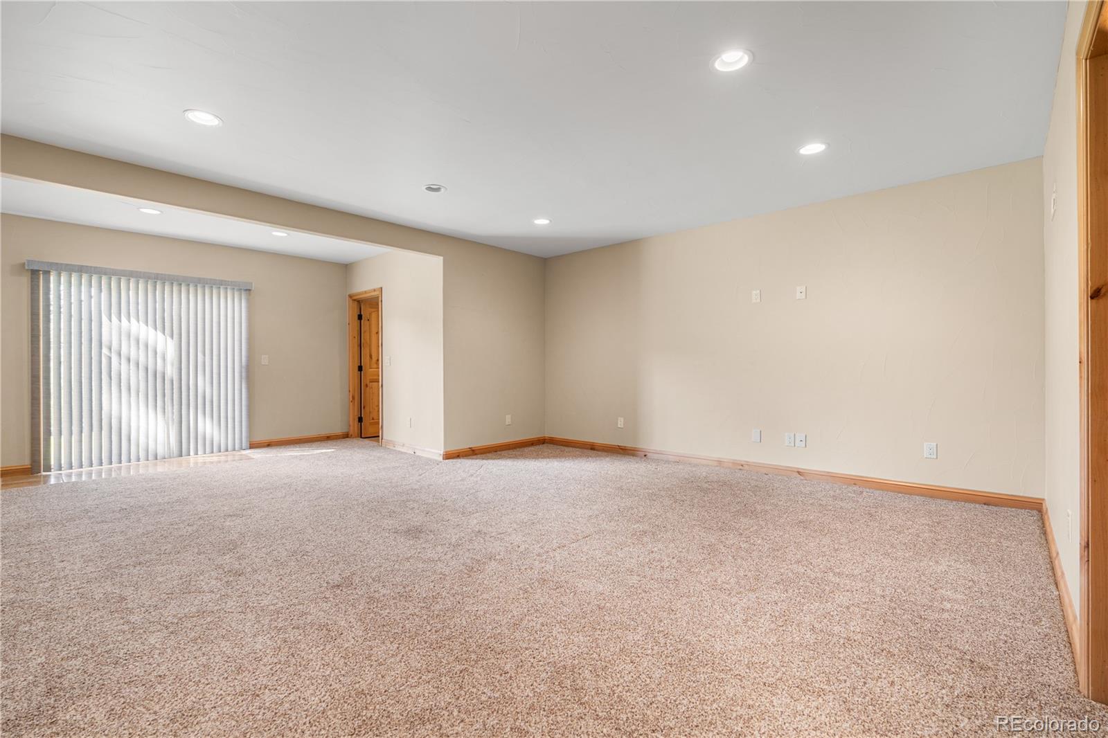 691 Cumberland Road Larkspur, CO 80118 - Photo 37 of 43 a view of an empty room with wooden floor
