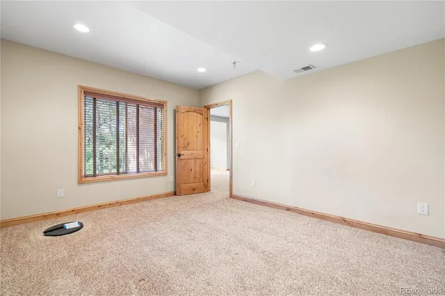 a view of a house with wooden floor next to a yard