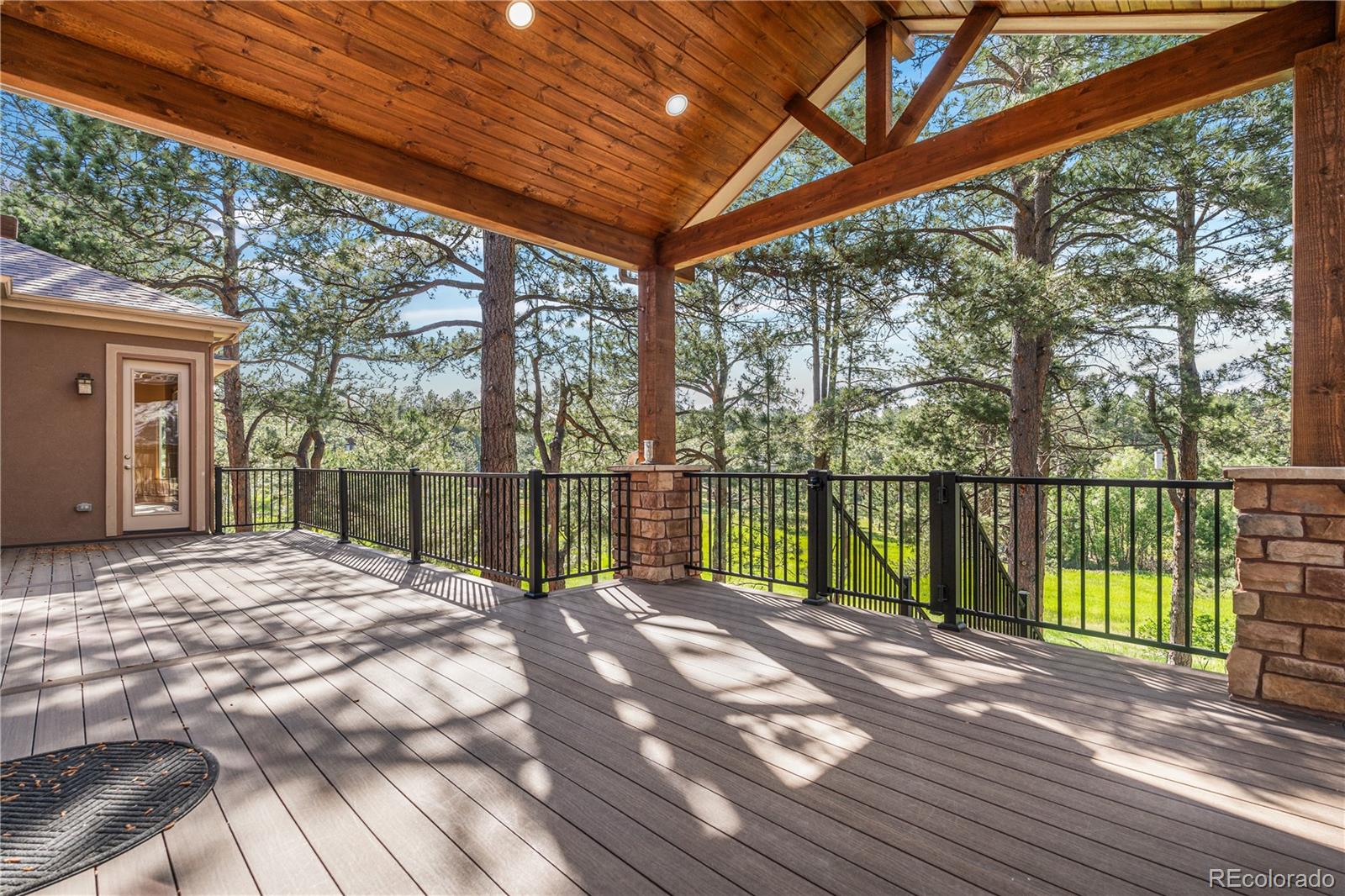 691 Cumberland Road Larkspur, CO 80118 - Photo 41 of 43 a view of a house with wooden floor next to a yard