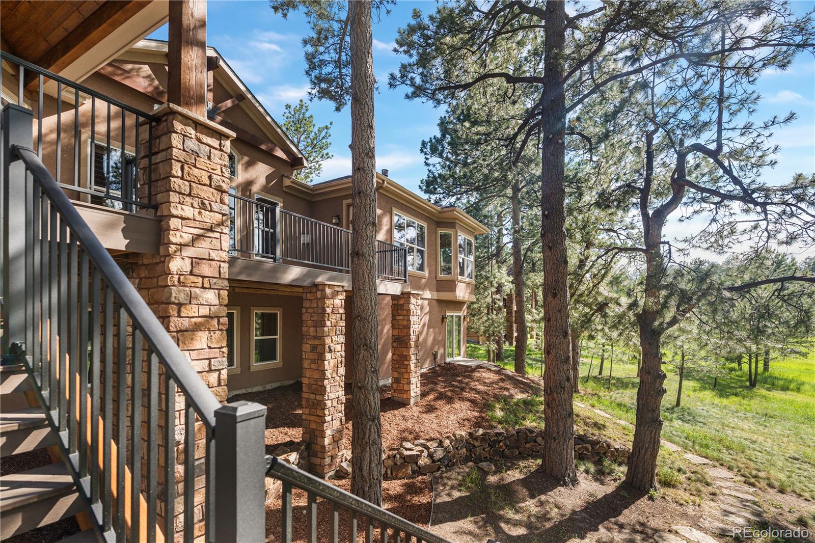 691 Cumberland Road Larkspur, CO 80118 - Photo 42 of 43 a view of a house with backyard of the house