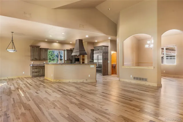 a view of a kitchen with cabinets and wooden floor