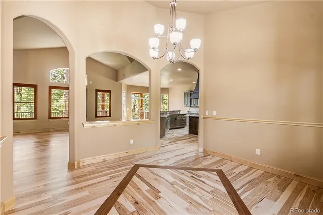 a view of a bedroom with wooden floor