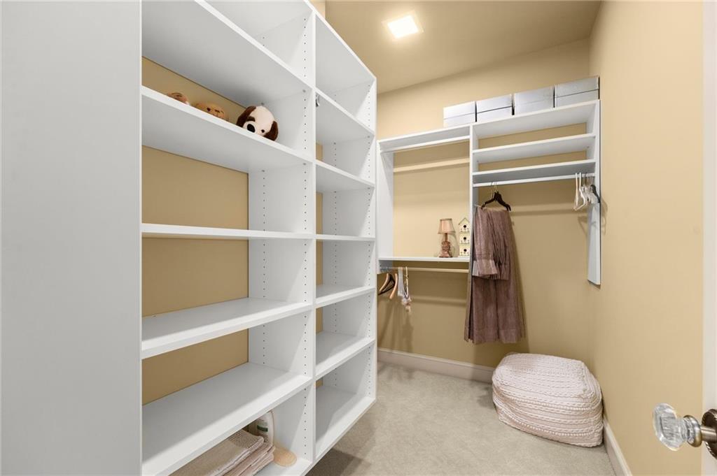 322 Edwards Brook Lane Canton, GA 30115 - Photo 67 of 99 a view of walk in closet with empty racks