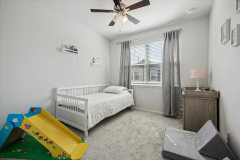 a bedroom with a bed and window