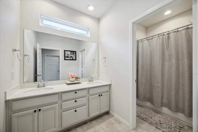 a bathroom with a double vanity sink and mirror