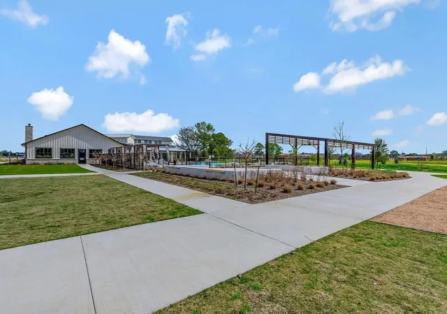 a view of a house with a yard and potted plants