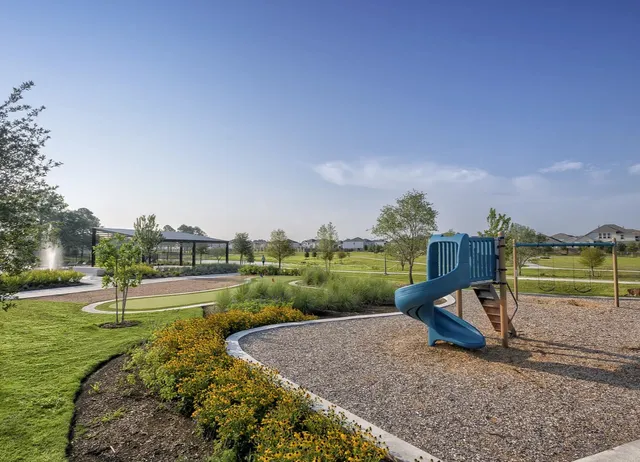 a view of a lake with a yard and a wooden fence
