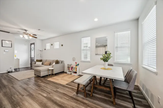 a living room with furniture and wooden floor