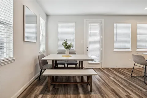 a view of a room with wooden floor and windows