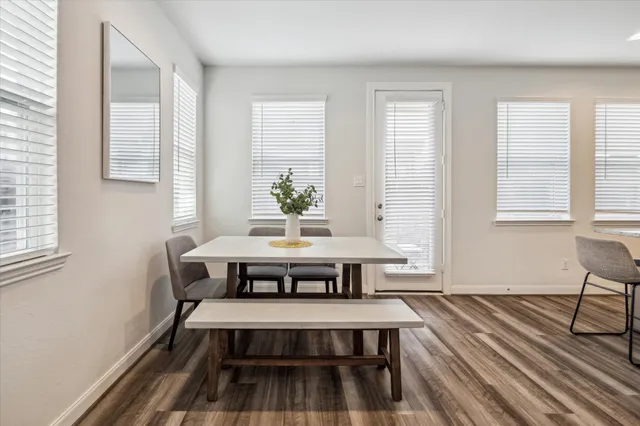 a view of a room with wooden floor and windows