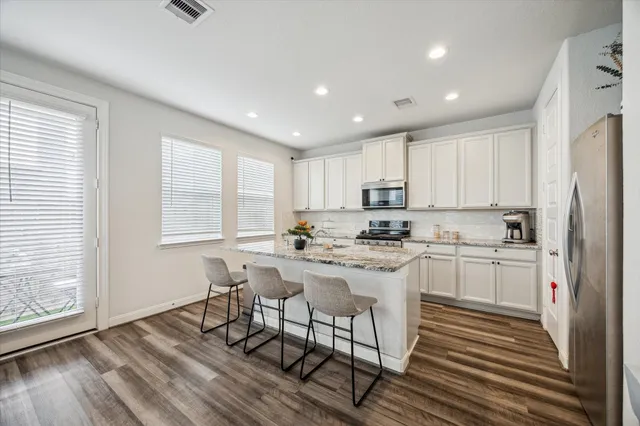 a kitchen with a sink a window and cabinets