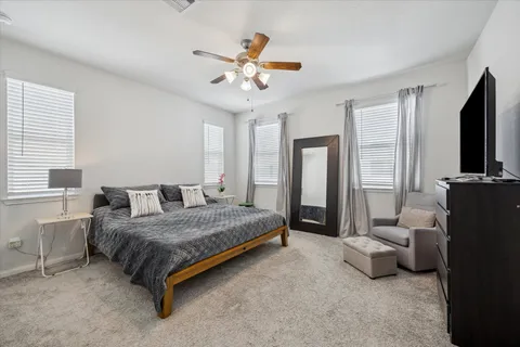 a bedroom with a bed furniture and a flat screen tv