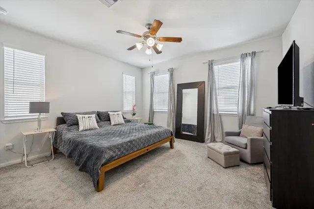 a bedroom with a bed furniture and a flat screen tv