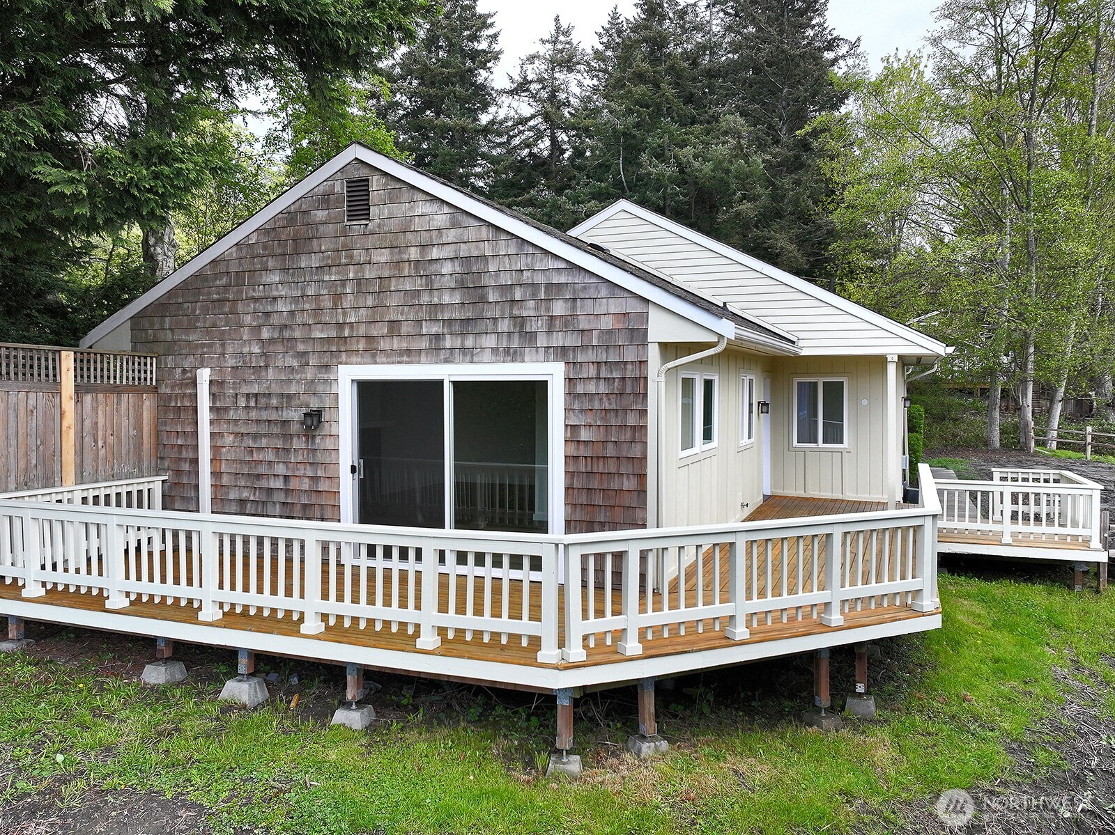 3760 Periwinkle Road Clinton, WA 98236 - Photo 6 of 34 a view of a house with a deck and a yard