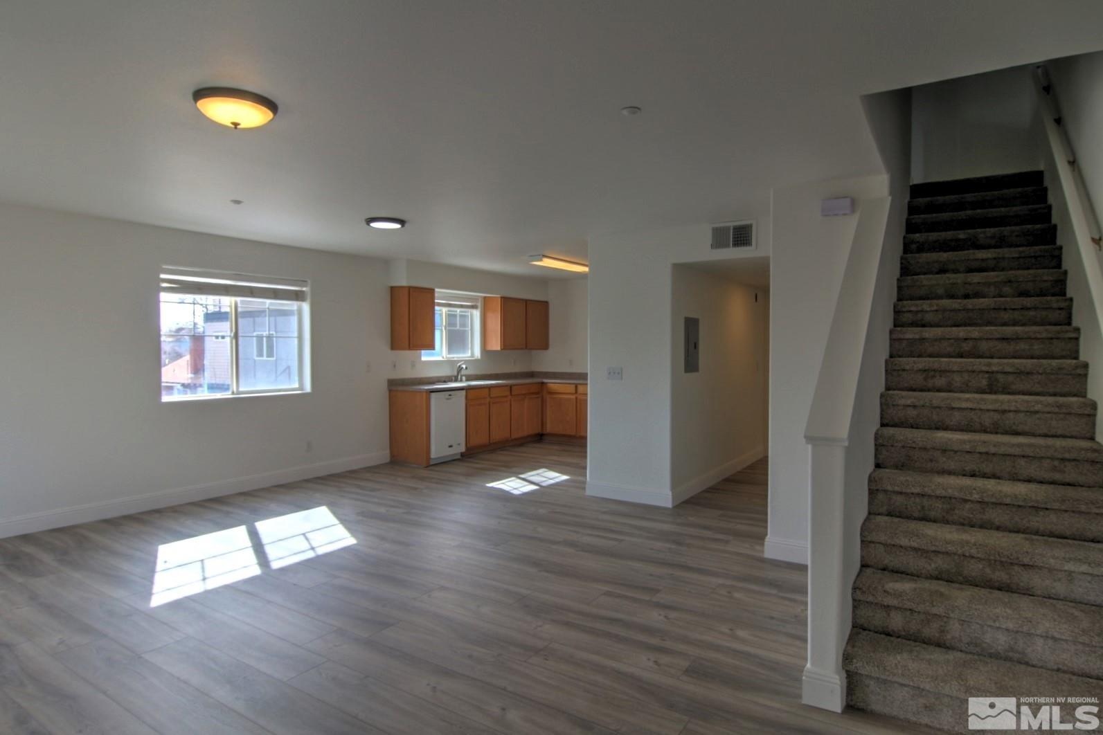 433 Holcomb Avenue Reno, NV 89502 - Photo 12 of 31 a view of empty room with wooden floor and kitchen