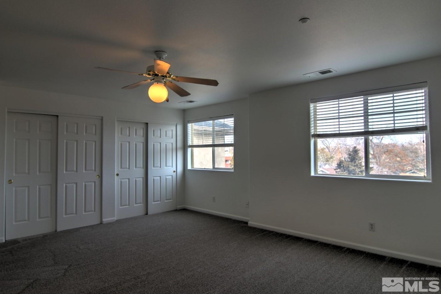 433 Holcomb Avenue Reno, NV 89502 - Photo 15 of 31 a view of an empty room with window and chandelier fan