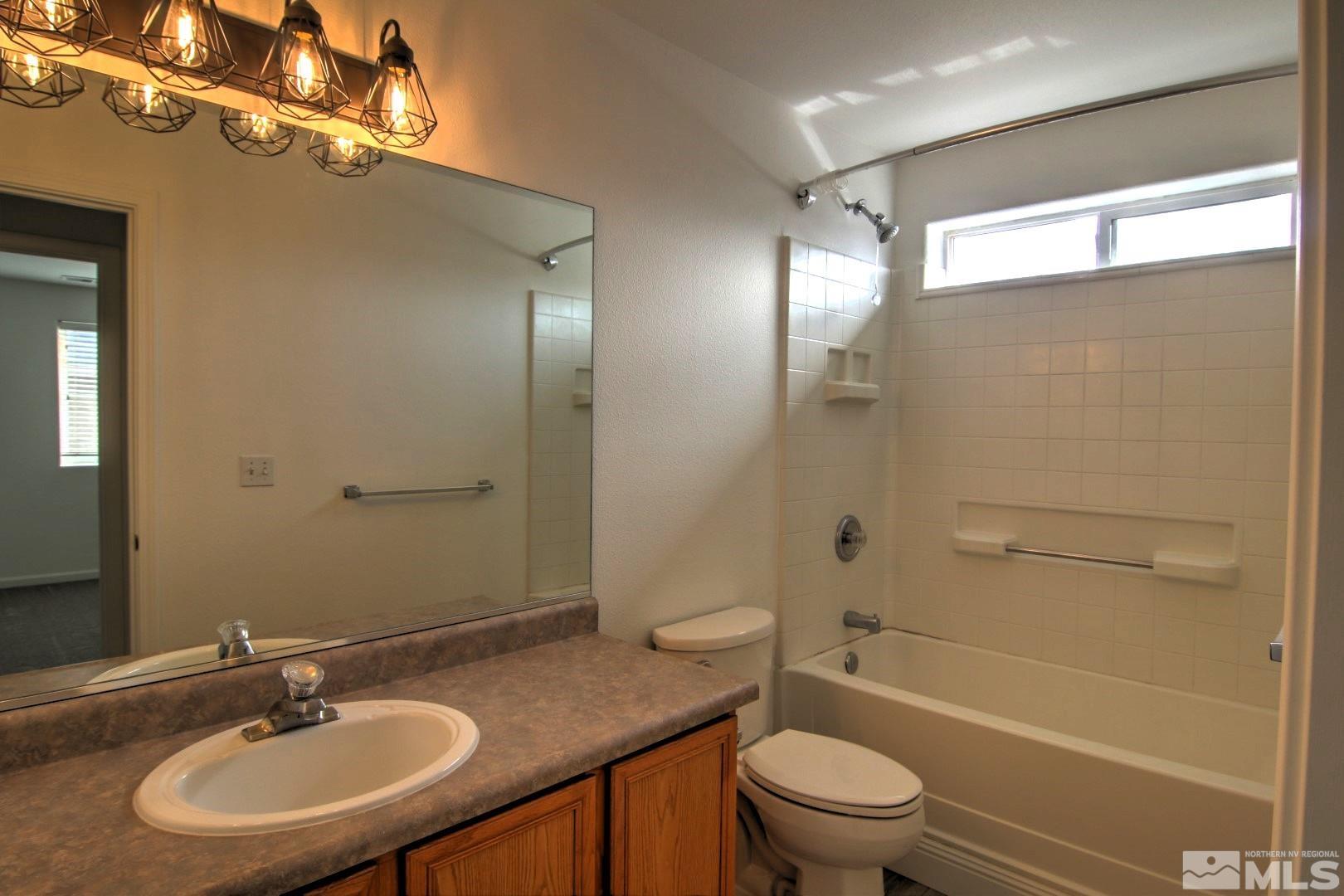 433 Holcomb Avenue Reno, NV 89502 - Photo 21 of 31 a bathroom with a granite countertop sink toilet and shower