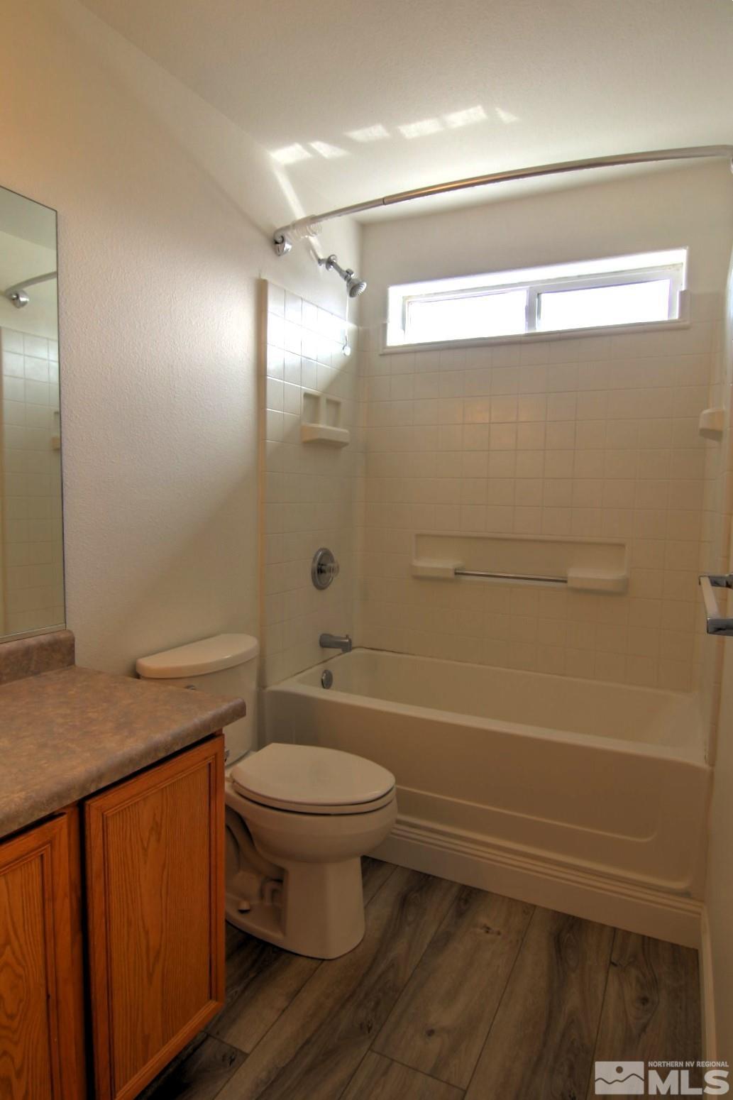 433 Holcomb Avenue Reno, NV 89502 - Photo 22 of 31 a bathroom with a granite countertop sink toilet and shower