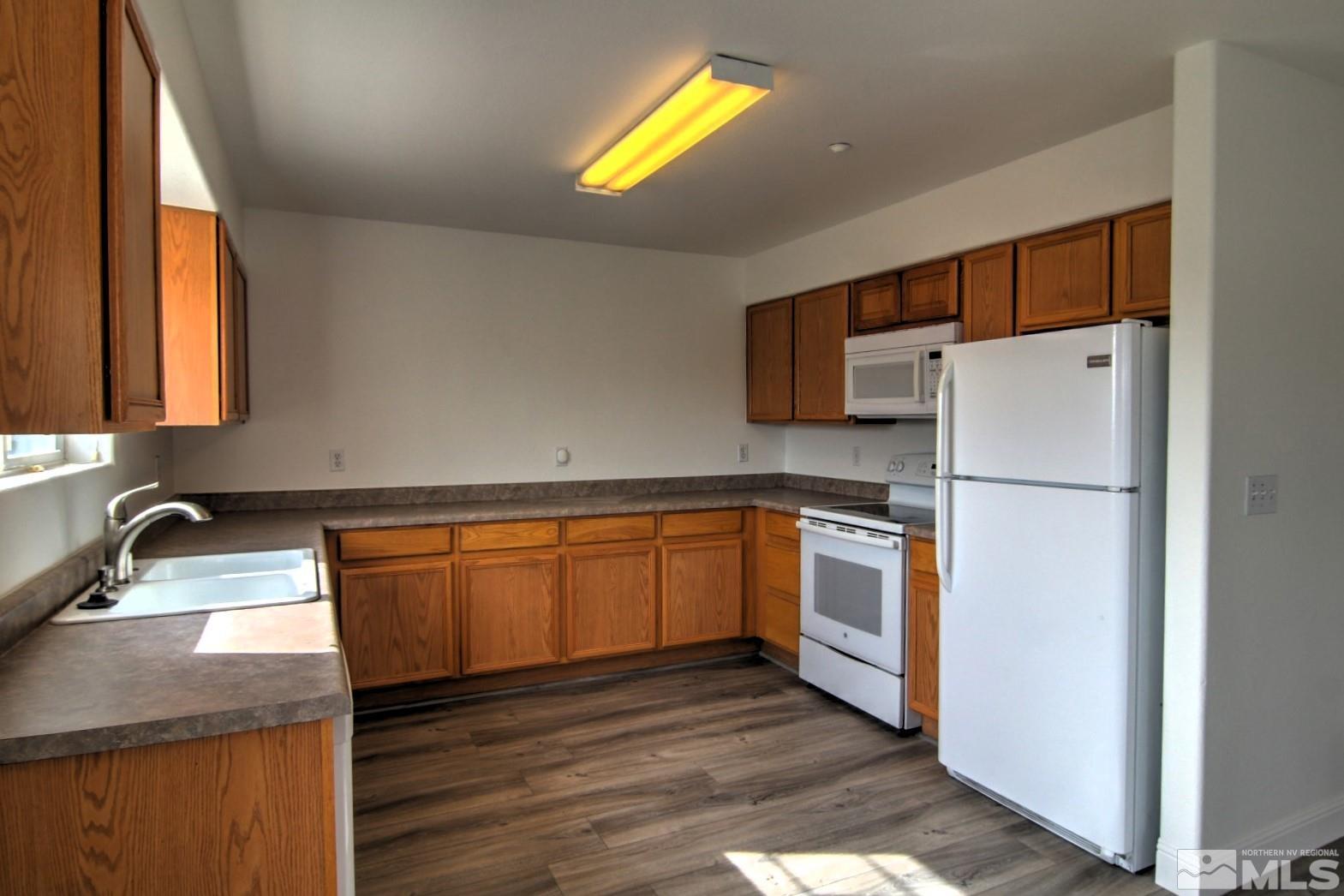 433 Holcomb Avenue Reno, NV 89502 - Photo 3 of 31 a kitchen with stainless steel appliances granite countertop a refrigerator sink and stove