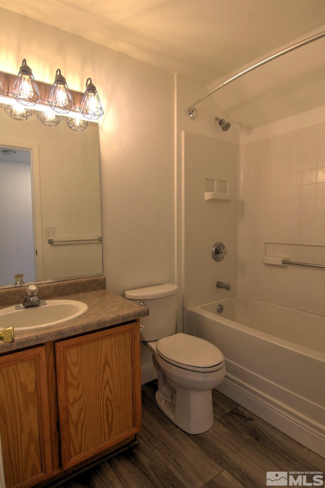 433 Holcomb Avenue Reno, NV 89502 - Photo 9 of 31 a bathroom with a granite countertop sink toilet and shower