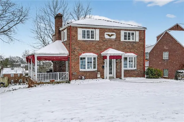 a front view of a house with glass doors and outdoor space