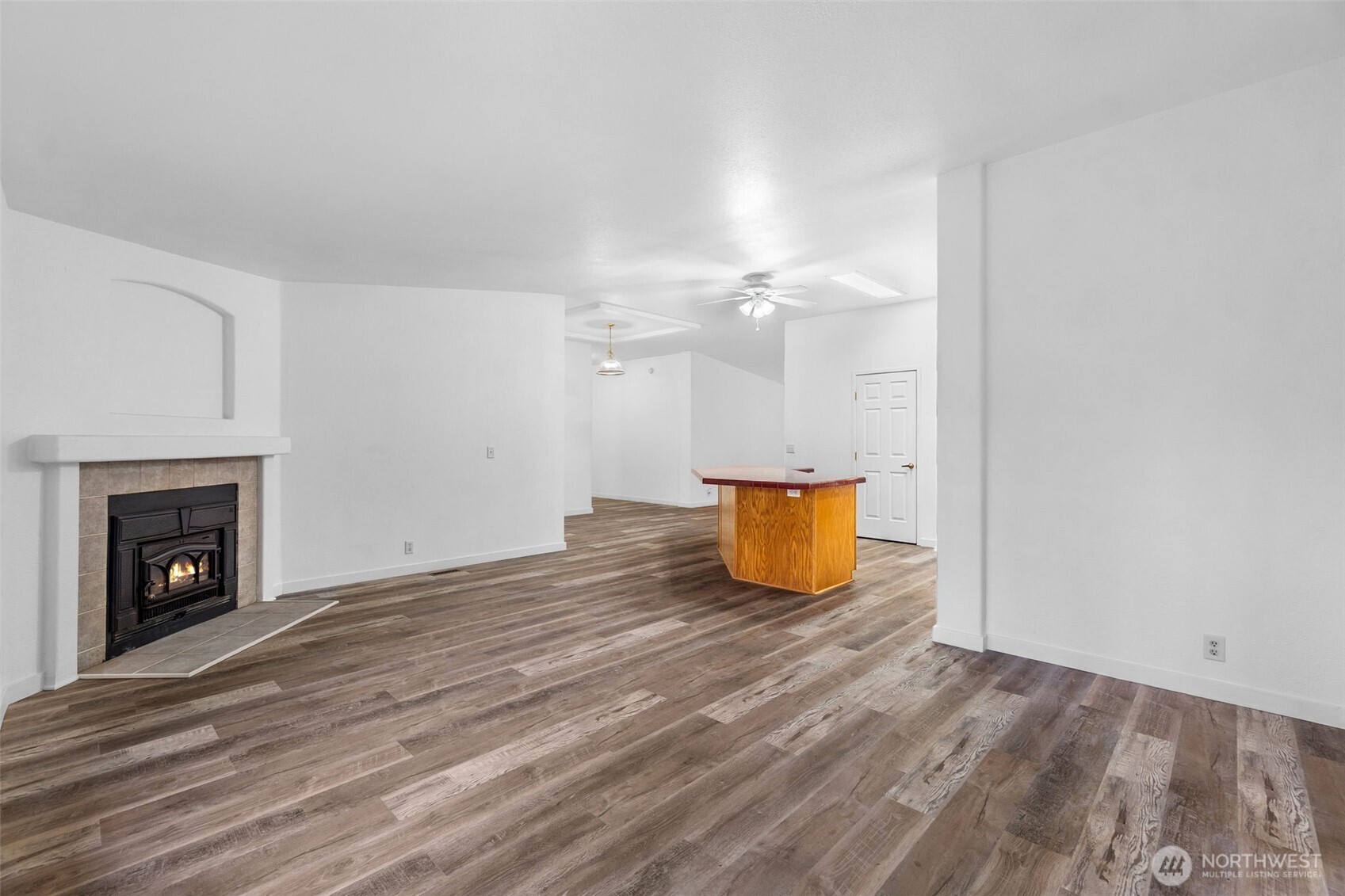71 East Rhododendron Place Shelton, WA 98584 - Photo 12 of 38 a view of an empty room with wooden floor and fireplace