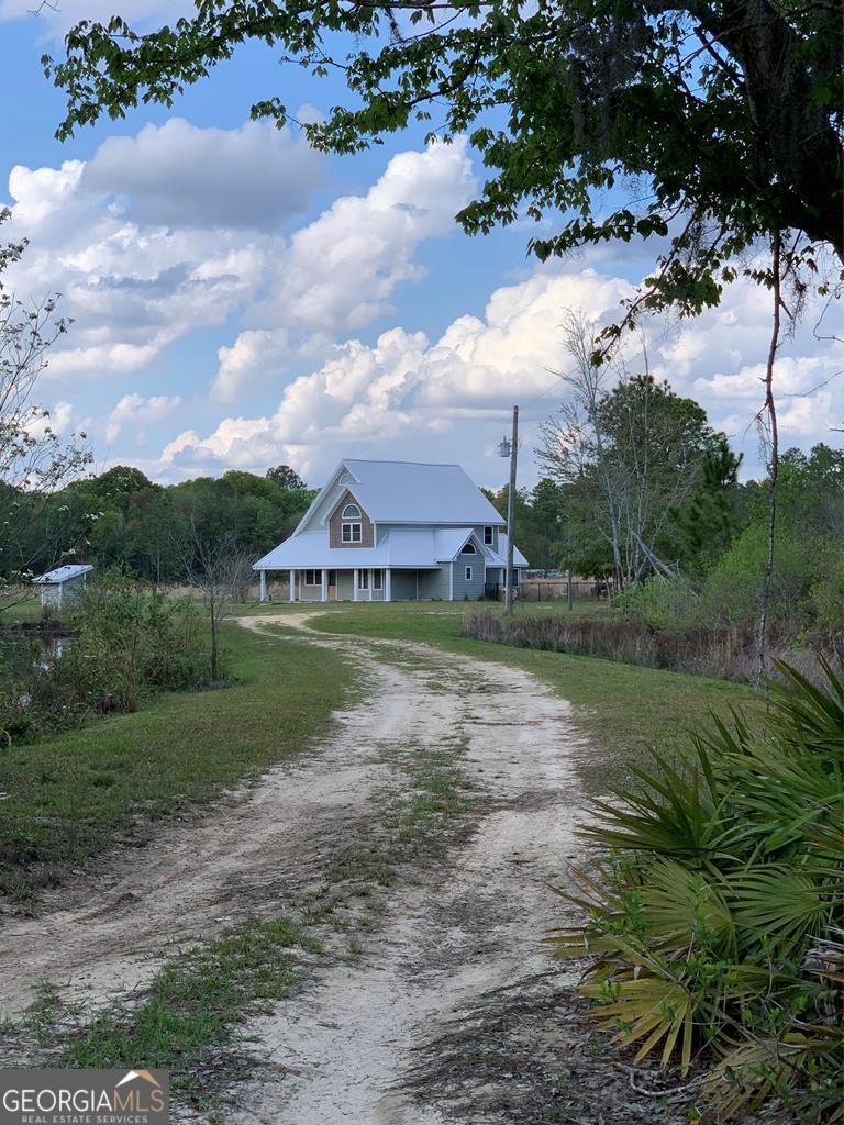 1213 Pretty Ford Road Baxley, GA 31513 - Photo 1 of 1 a view of a house with a big yard