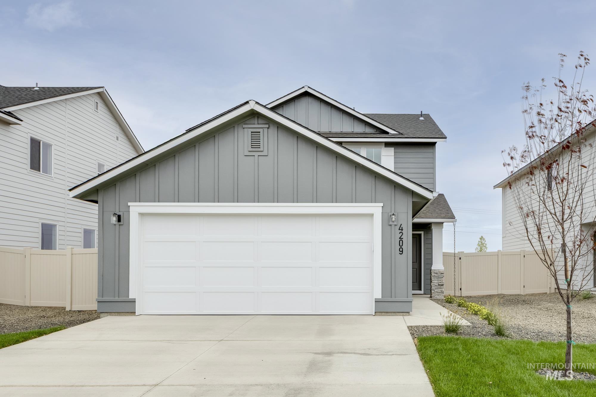 4209 North Delphi Avenue Meridian, ID 83646 - Photo 1 of 1 View of front of house featuring board and batten siding, a shingled roof, driveway, and a garage