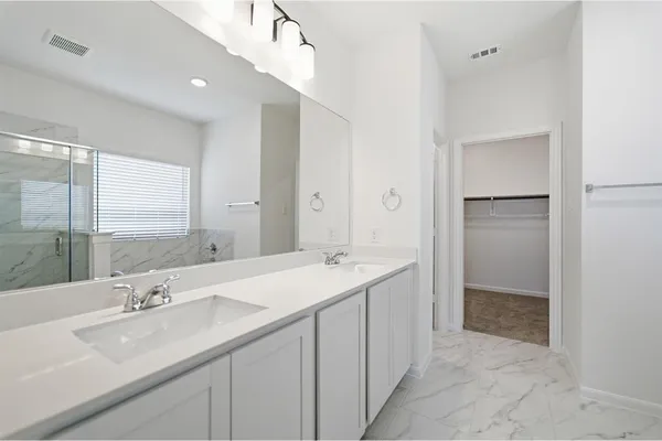 a bathroom with a double vanity sink and mirror
