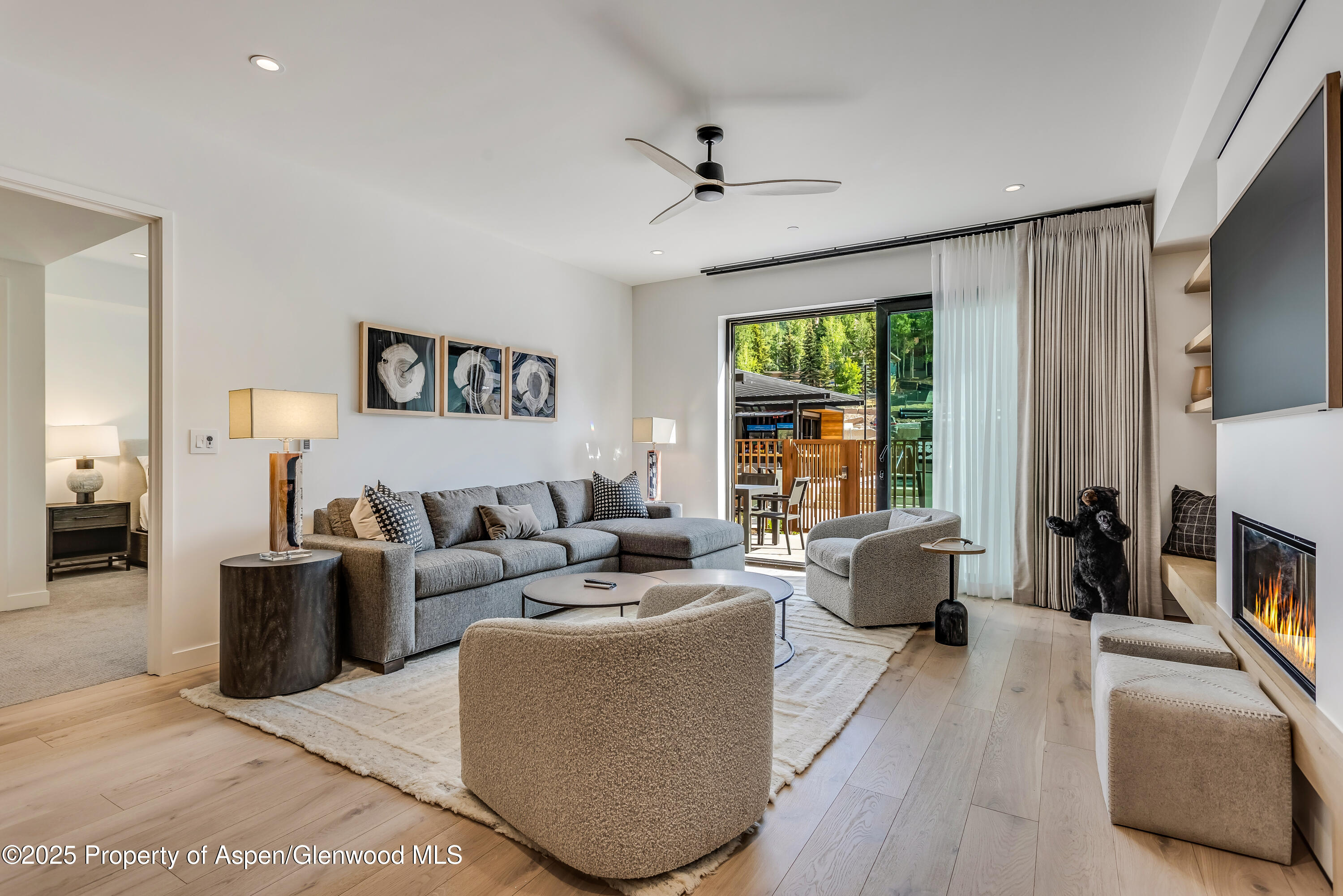 a living room with furniture large window and flat screen tv