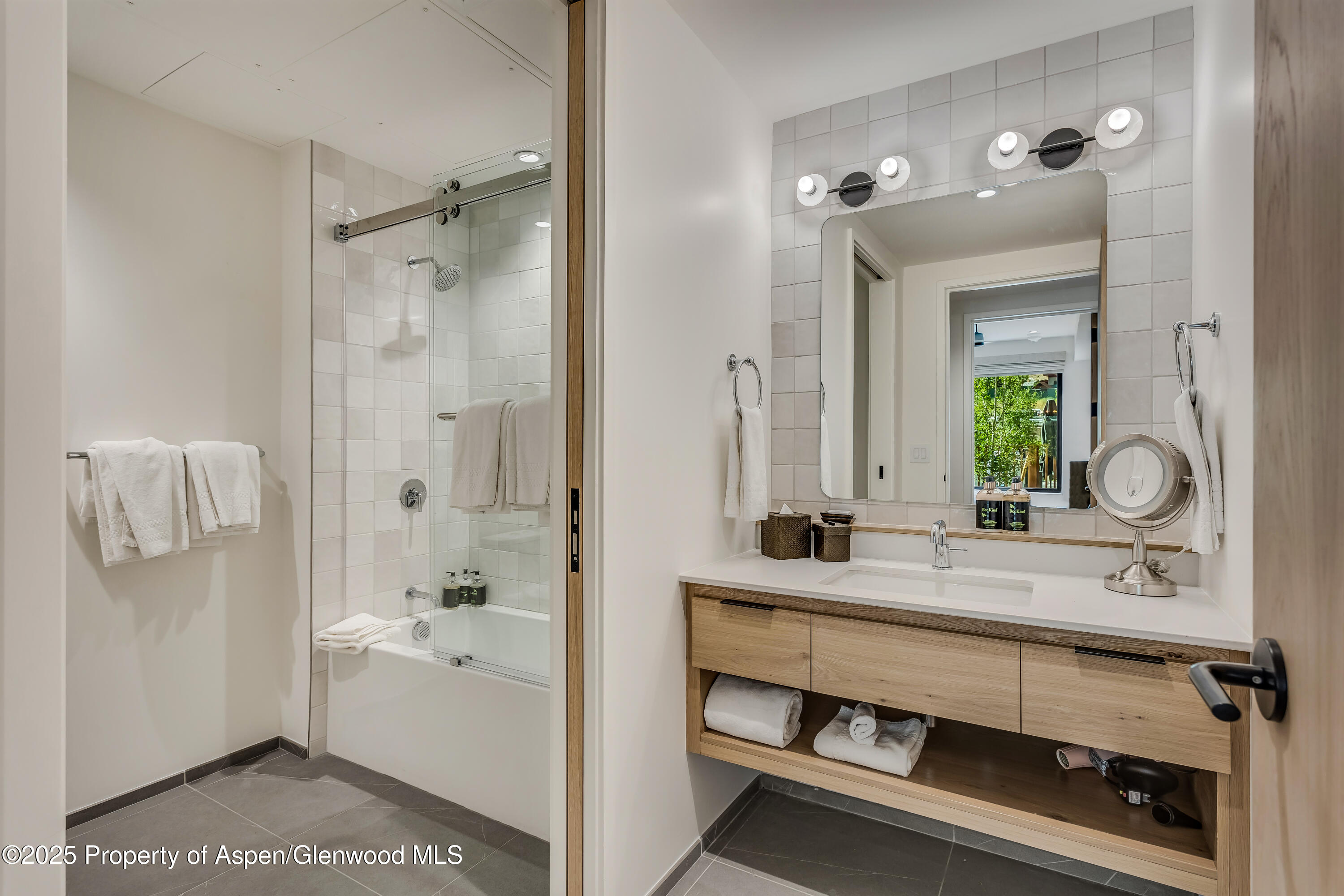 119 Wood Road, Unit 103 Snowmass Village, CO 81615 - Photo 16 of 23 a bathroom with a tub a sink and mirror