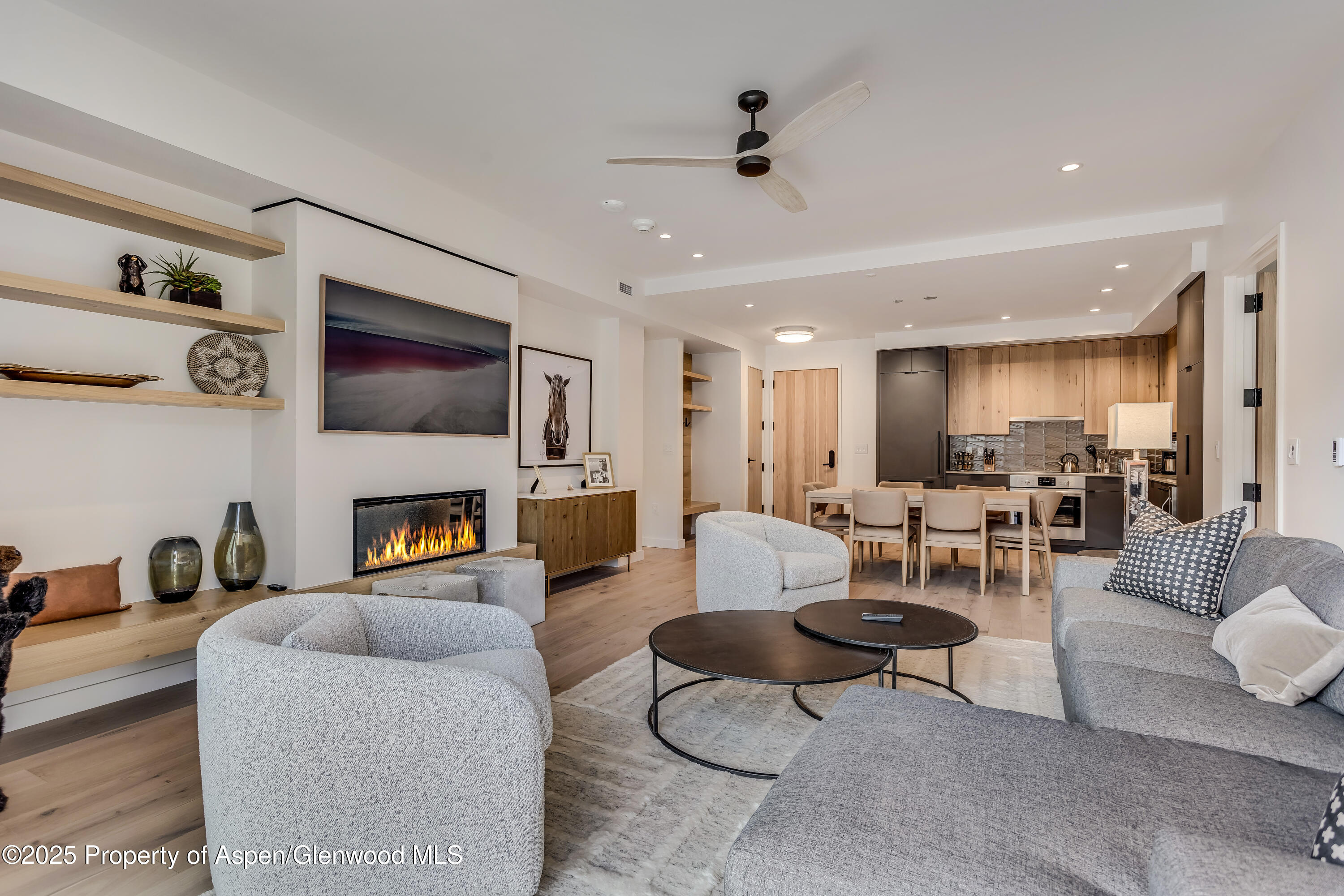 119 Wood Road, Unit 103 Snowmass Village, CO 81615 - Photo 2 of 23 a living room with furniture and a fireplace