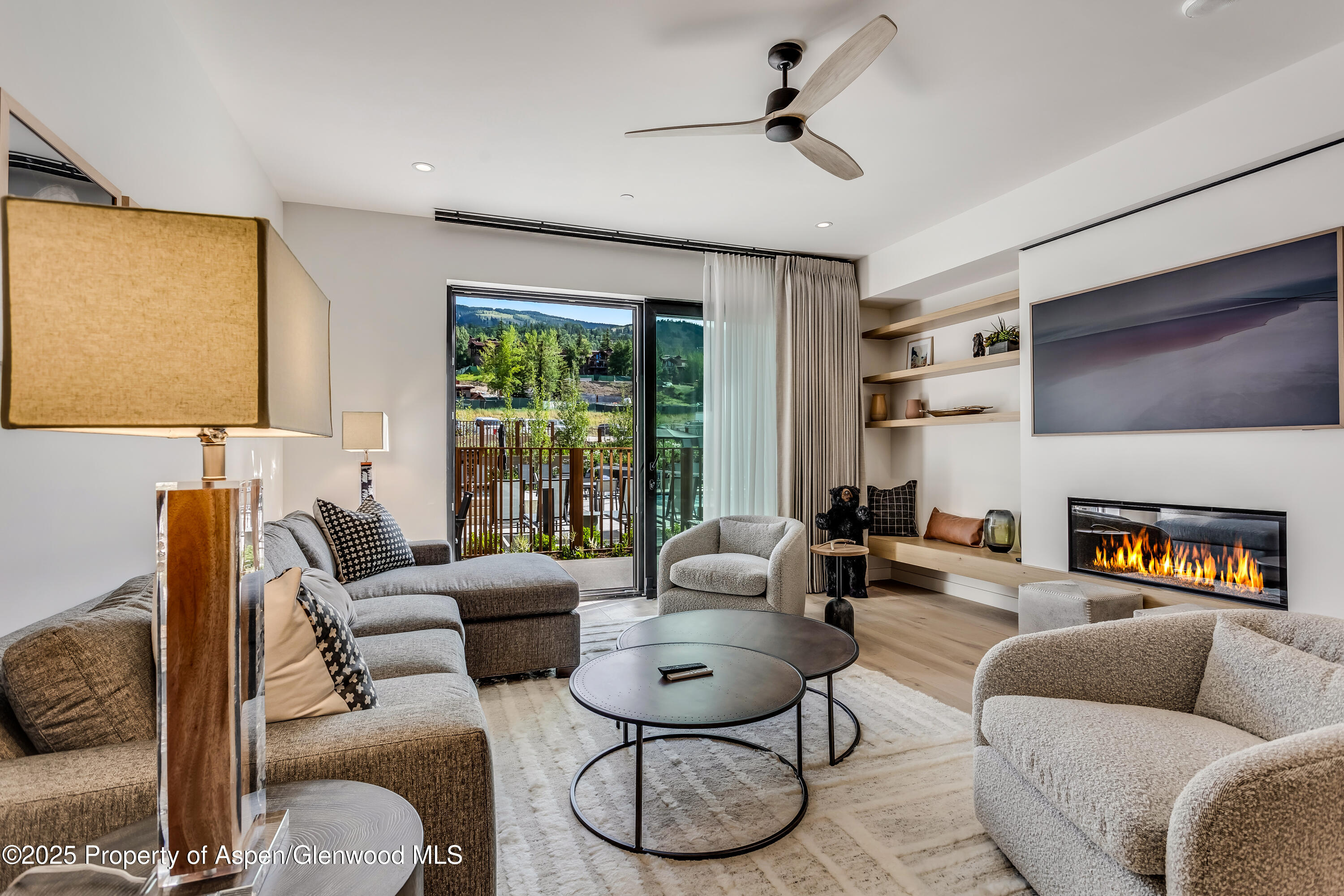 119 Wood Road, Unit 103 Snowmass Village, CO 81615 - Photo 3 of 23 a living room with furniture and a large window