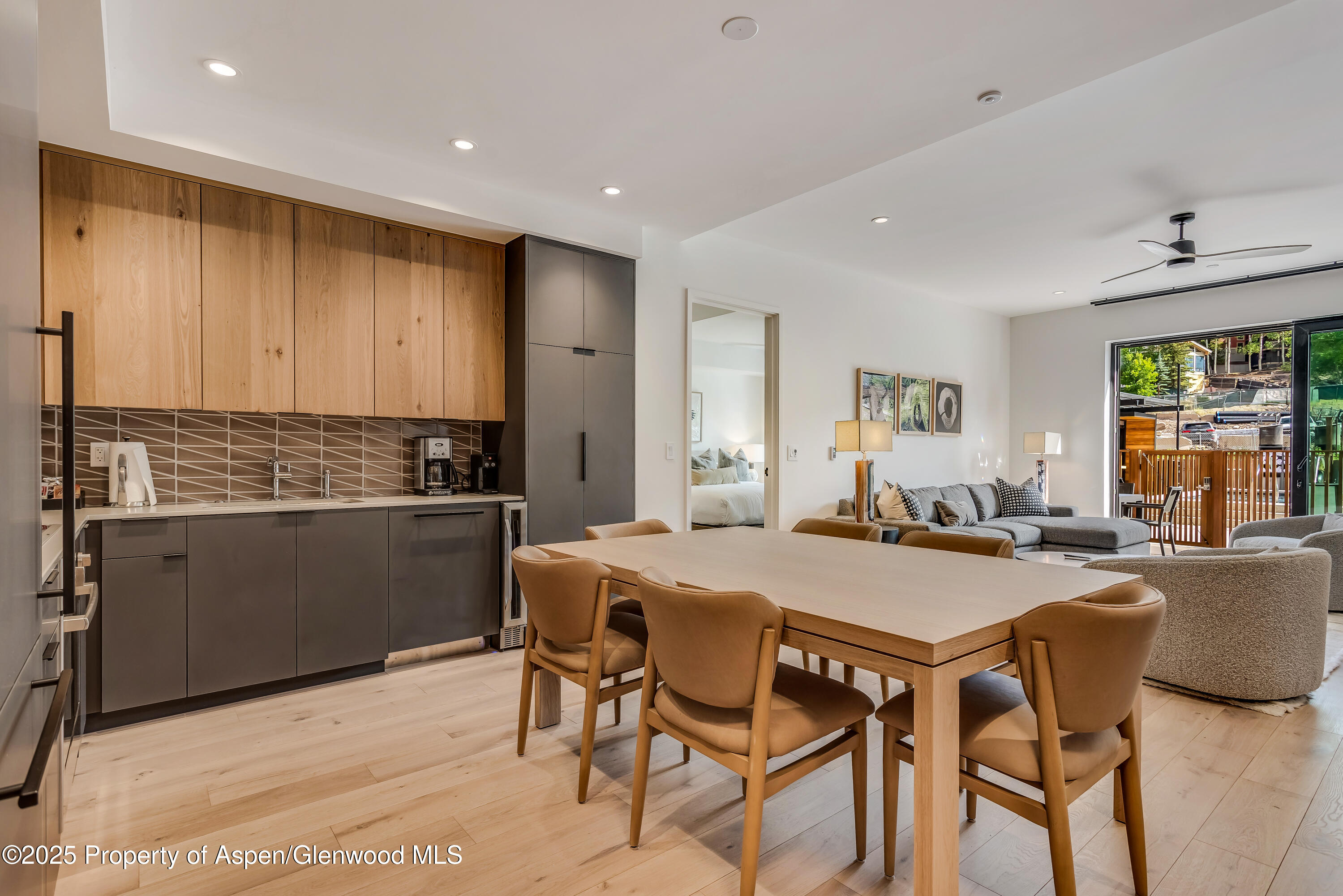 119 Wood Road, Unit 103 Snowmass Village, CO 81615 - Photo 8 of 23 a kitchen with a table chairs stove and refrigerator