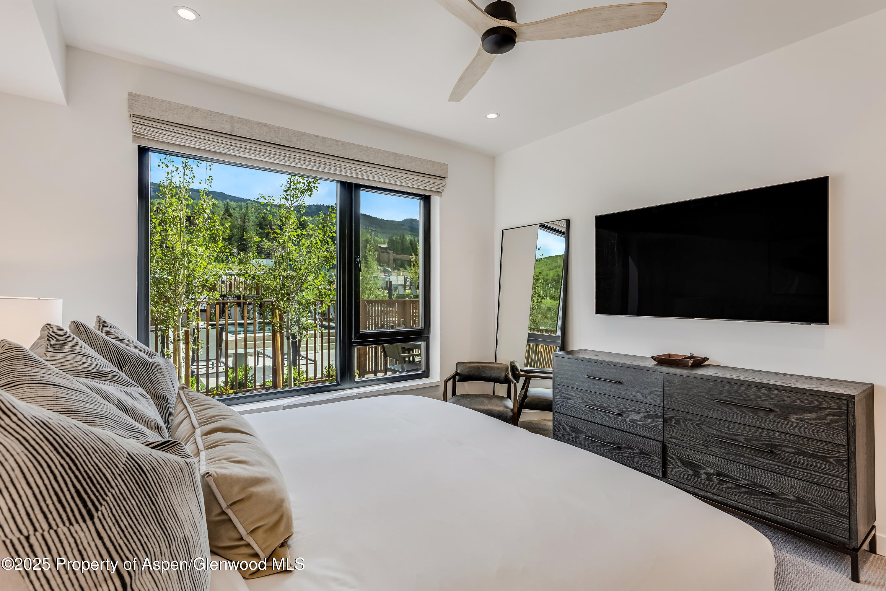 119 Wood Road, Unit 103 Snowmass Village, CO 81615 - Photo 9 of 23 a bedroom with a bed and a flat screen tv