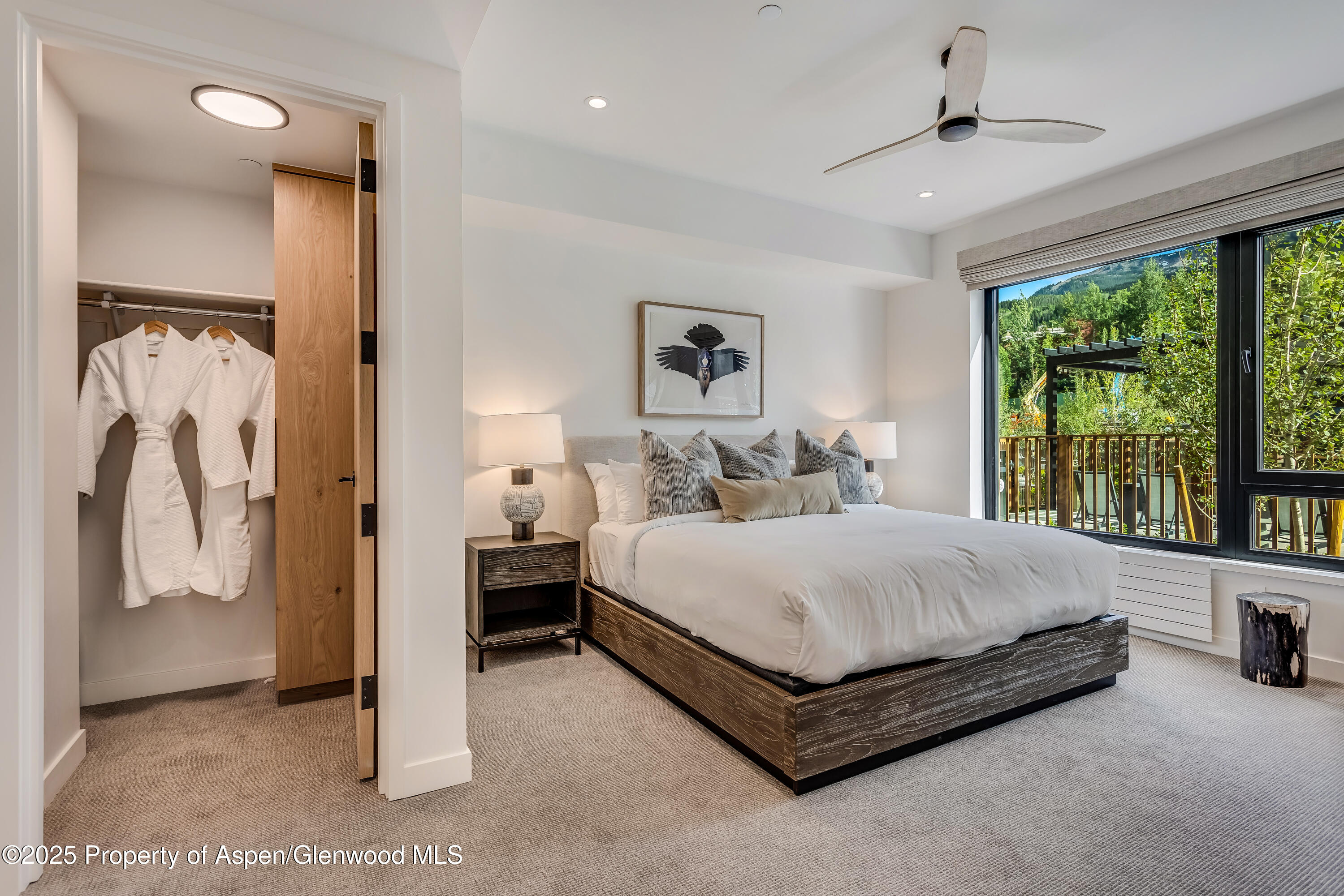 119 Wood Road, Unit 103 Snowmass Village, CO 81615 - Photo 10 of 23 a spacious bedroom with a bed and large window