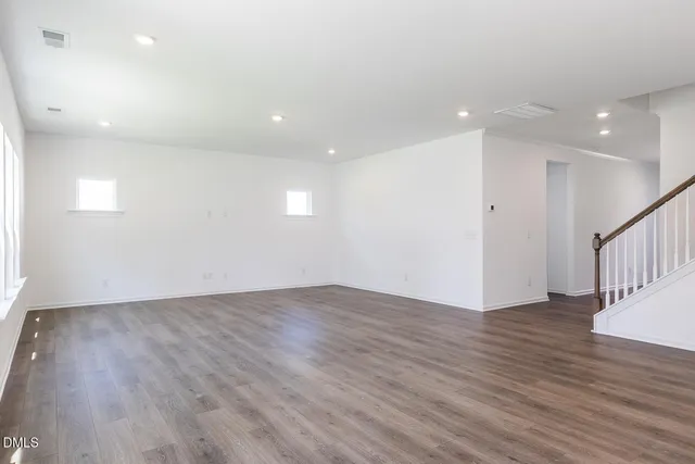 a view of a kitchen with wooden floor and a sink