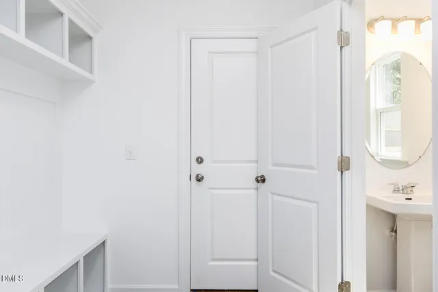 a bathroom with a shower sink vanity and a mirror