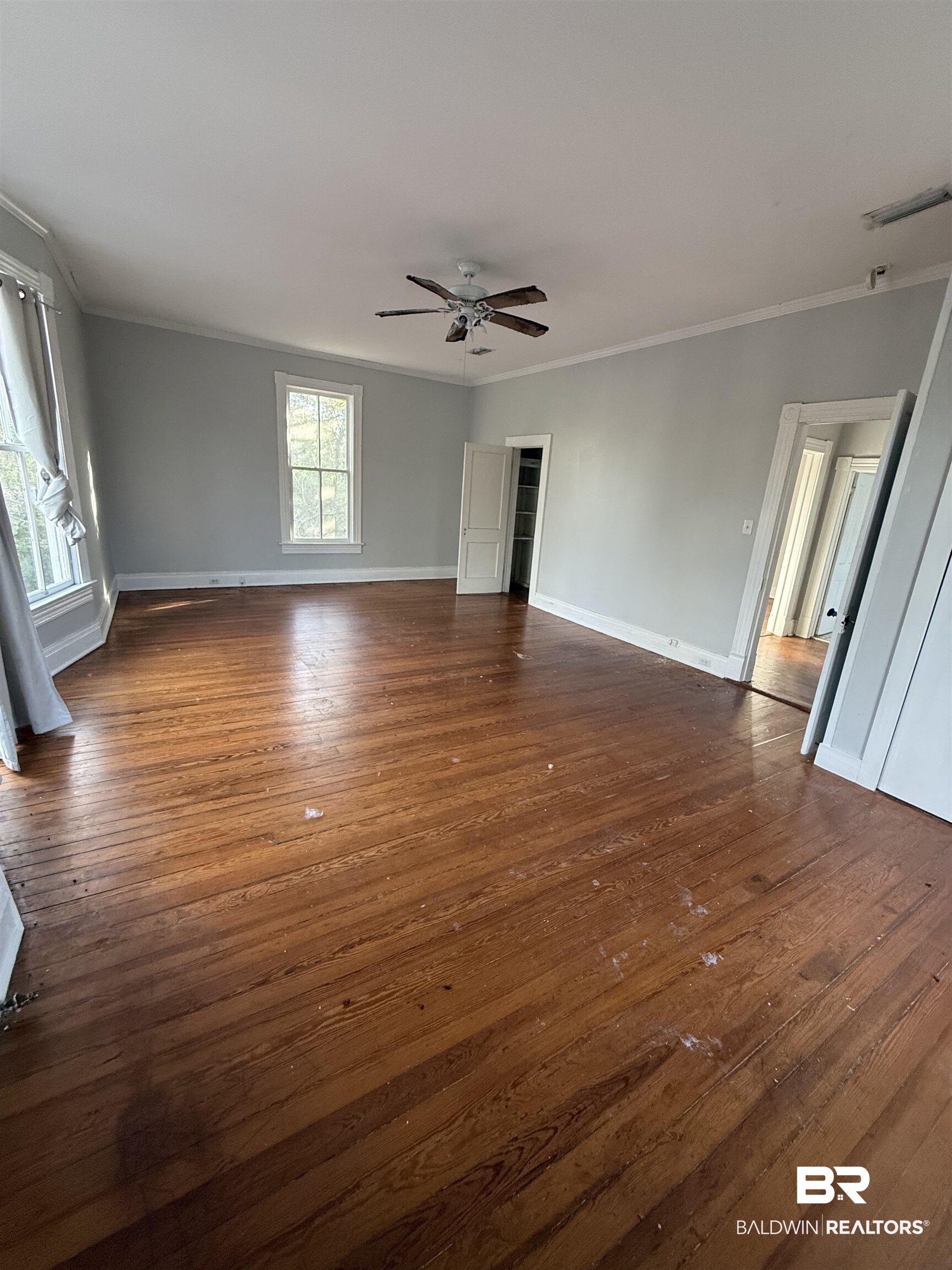 352 South Ann Street Mobile, AL 36604 - Photo 16 of 20 Unfurnished living room with dark wood-style floors, a ceiling fan, and crown molding